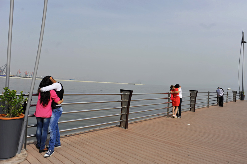 BAKU, AZERBAIJAN.  Couples make out on a dock on the Bulvar, the Caspian seaside promenade, in the middle of the afternoon on May 4, 2012.
