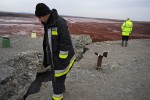 AJKA, HUNGARY.  Disaster management workers inspect the cracks in the wall of the toxic red alumina sludge reservoir at the MAL plant on November 22, 2010, seven weeks after a rupture caused a torrent of the hazardous material to pour into the surrounding countryside and into several villages including Kolontar and Devecser, Hungary, killing ten, including a 14 month old baby, injuring hundreds and leaving several families homeless.