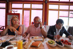 BAKU, AZERBAIJAN.  (Center) Ibrahim Ibrahimov, an Azerbaijani oligarch and billionaire, talks on his cell phone at the breakfast table while seated between his wife (at left) Valida Ibrahimli and son Huseyn, 18, in one of several houses on his Caspian seaside property he used to inhabit with his family in the Garadagh region just southwest of Baku, Azerbaijan on July 18, 2012. Ibrahimov is the developer behind the Khazar Islands artificial islands project; in his private life, he enjoys building a home for his family, moving in, and then quickly tires of the property before building a new home on an adjacent lot on his seaside lands.  (Credit: Amanda Rivkin/VII Mentor Program for The New York Times Magazine)