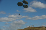 DRAWKSO POMORSKIE TRAINING AREA, POLAND.  American soldiers from the Fourth of the 319th Airborne Field Artillery Regiment of the 173rd Airborne Brigade Combat Team monitor as a howitzer drops from a C-17 aircraft that took off from Nuremberg, Germany before American soldiers parachute to the ground on June 15, 2015.  NATO is engaged in a multilateral training exercise {quote}Saber Strike,{quote} the first time Poland has hosted such war games, involving the militaries of Canada, Denmark, Germany, Poland, and the United States.