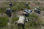 DRAWSKO POMORSKIE TRAINING AREA, POLAND.  Backpacks belonging to the paratroopers of the Fourth of the 319th Airborne Field Artillery Regiment of the 173rd Airborne Brigade Combat Team lay on the ground following an airdrop from a C-17 aircraft that took off from Nuremberg, Germany and dropped on June 15, 2015.  NATO is engaged in a multilateral training exercise {quote}Saber Strike,{quote} the first time Poland has hosted such war games, involving the militaries of Canada, Denmark, Germany, Poland, and the United States.