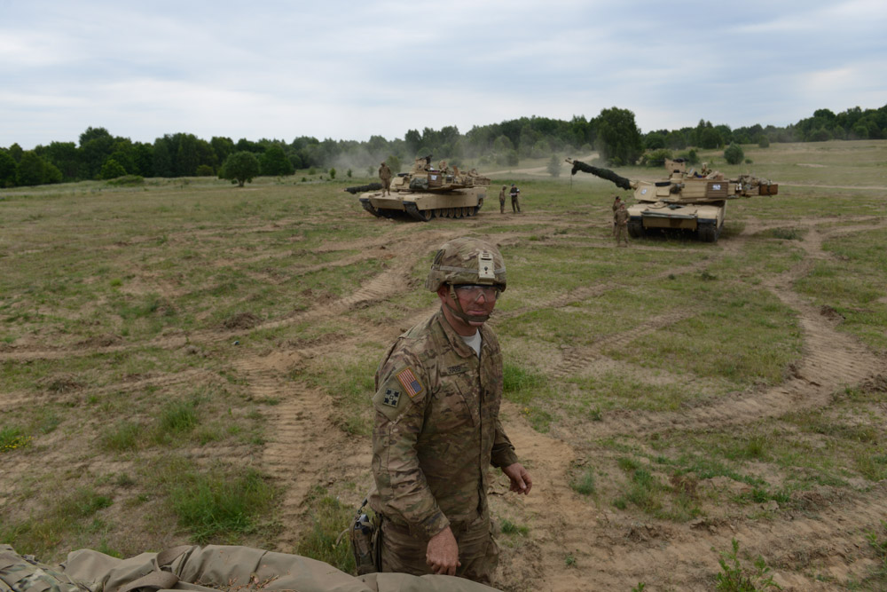 DRAWSKO POMORSKIE TRAINING AREA, POLAND.  American soldiers with Delta Company, 2nd Battalion, 7th Infantry Regiment, 1st Armored Brigade Combat Team, 3rd Infantry Division with M1A2 Abrams tanks after a tank training exercise practicing infiltration on June 12, 2015.  NATO is engaged in a multilateral training exercise {quote}Saber Strike,{quote} the first time Poland has hosted such war games, involving the militaries of Canada, Denmark, Germany, Poland, and the United States.