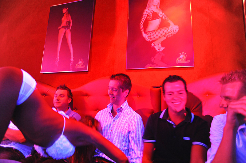 PRAGUE, CZECH REPUBLIC.  Stag and soon to be married (second from left) Michael Klos, 23, receives a table top lap dance as friends (l-r) Roald de Jongh, 24, Ronald Stelt, 23 and Herman Bruinslol, 23, of Rotterdam, the Netherlands look on at Hot Peppers in Prague, Czech Republic on August 12, 2011.
