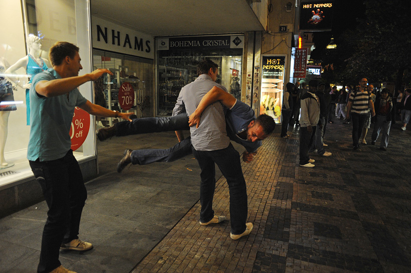 PRAGUE, CZECH REPUBLIC.  Stag tourists Angelo Eleveld, 22, picks up and spins his friend Sietse Dehaam, 23, as Roald de Jongh, 24, of Rotterdam, the Netherlands tries to spank him as he turns mid-way through the night on Weneslaus Square in Prague, Czech Republic on August 12, 2011.