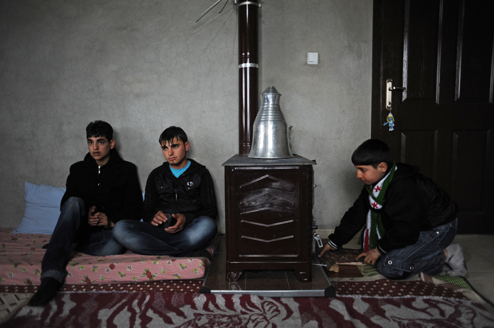 GUVECCI, TURKEY.   Syrians who fled from the year old rebellion against the rule of Bashar Al Assad in neighboring Syria sit in the home of a relative just across the border on February 27, 2012.  Turkey has seen a continued influx of refugees from the Syrian conflict and border towns like Guvecci have watched as their populations have more than doubled.