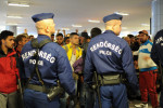 BUDAPEST, HUNGARY.  Police block the front of the line as refugees wait to board trains to Vienna before embarking onward to Germany, Switzerland and Sweden in the Keleti Train Station lower level on September 12, 2015.  Hungarian officials have struggled to control the flow of refugees through their country, building a wall at its borders, multiple refugee camps and ultimately attempting to prevent stampedes to board trains by those who made it all the way to Keleti Station in Budapest and the nationalist Prime Minister Viktor Orban has faced tremendous international criticism but no public condemnation in the process for his words and deeds.