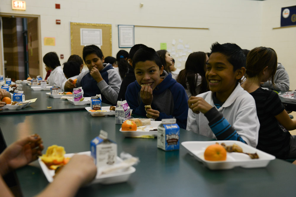 CHICAGO, ILLINOIS.  Fifth graders in Ms. Heidy's class enjoy their school lunch in the cafeteria at the Nathanael Greene Elementary School in the McKinley Park neighborhood on December 19, 2014.  All but one student in Ms. Heidy's class receives food assistance in the form of the Supplemental Nutritional Assistance Program or SNAP, which includes a free lunch.