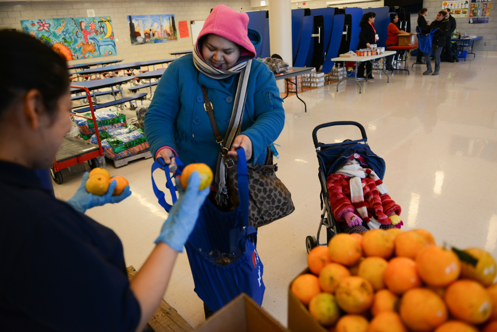 CHICAGO, ILLINOIS.  The Greater Chicago Food Depository runs the Healthy Kids Market which distributes nutritious foods and basic essentials to qualifying parents from the cafeteria of the Calmeca Academy of Fine Arts and Dual Language School in the Brighton Park neighborhood on January 15, 2015.  One in six Chicagoans requires food assistance.