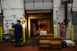CHICAGO, ILLINOIS.  Workers prepare for morning pick-ups at the loading dock of Cougle Wholesale Poultry and Meats in the Fulton Market meatpacking district of the West Loop on December 22, 2014.  Cougle is a niche processor, processing poultry and meat on a scale that fits mid-market needs.