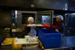 CHICAGO, ILLINOIS.  Employees of Gourmet Gorilla pull baked chicken from an oven in the kitchen in the West Town neighborhood on February 12, 2015.