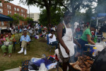 CHICAGO, ILLINOIS.  Melody Miller of St. Paul, Minnesota cooks jerk chicken and turkey legs over the grill during the back-to-school Bud Biliken Day Parade and Picnic, an annual tradition on the South Side, in Washington Park on August 9, 2015.