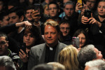 DE PERE, WISCONSIN.  A priest stands among students as Republican presidential frontrunner Donald Trump signs autographs and does what is known as {quote}a rope line{quote} in the Webster Theater at St. Norbert College after he gave a speech primarily on the topic of success not his presidential campaign on March 30, 2016.