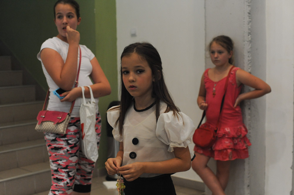 SIMANOVCI, SERBIA.  Girls who will dance on stage during the taping of the finale of {quote}Pinkove Zvezdice,{quote} or {quote}Little Pink Stars,{quote} wait backstage at the Pink TV studios before the finale on July 4, 2015.  {quote}Pinkove Zvezdice,{quote} is the junior program of {quote}Pinkove Zvezde,{quote} the premier turbofolk showcase on Pink TV, one of the primary networks showcasing turbofolk, although the child contestants on {quote}Pinkove Zvezdice{quote} are more likely to sing classic pop songs than anything regional.