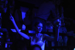 BELGRADE, SERBIA.  A clubgoer at Bard, a nightclub on a splav or barge on the Danube River, dances to fast-paced turbofolk hits by Dara Bubamara on the main dance floor of the club on July 8, 2015.  Dara Bubamara's career extends back to 1989 when she got her start on television singing songs by Lepa Brena.
