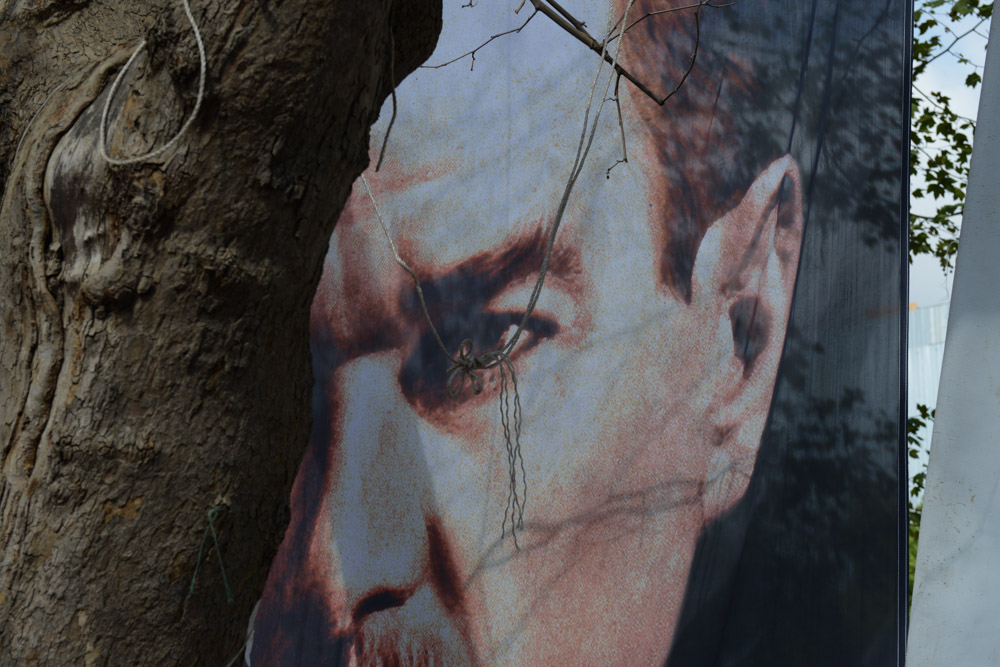 ISTANBUL, TURKEY.  A fragment of a poster of ataturk is seen in Gezi Park after 12 days of occupying the park after police retook the adjacent Taksim Square but left demonstrators in the park on June 13, 2013.   Turkish Prime Minister Recep Tayyip Erdogan has offered a referendum on the park to residents of Istanbul, despite there being no law allowing for such practices, and telling demonstrators to evacuate the park as patience with the demonstration is over.