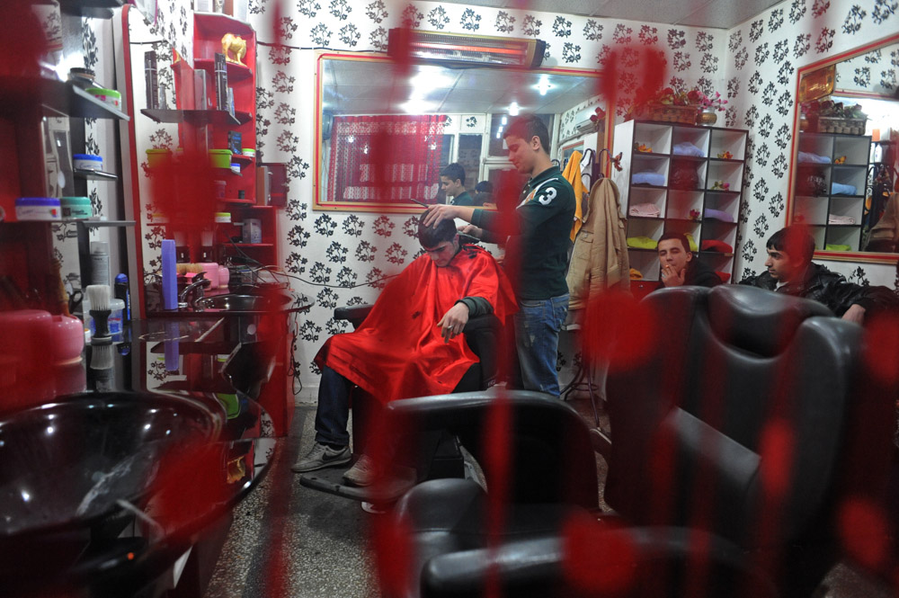 DIYARBAKIR, TURKEY.  A young man receives a haircut in a hair salon in the old city on February 22, 2012.
