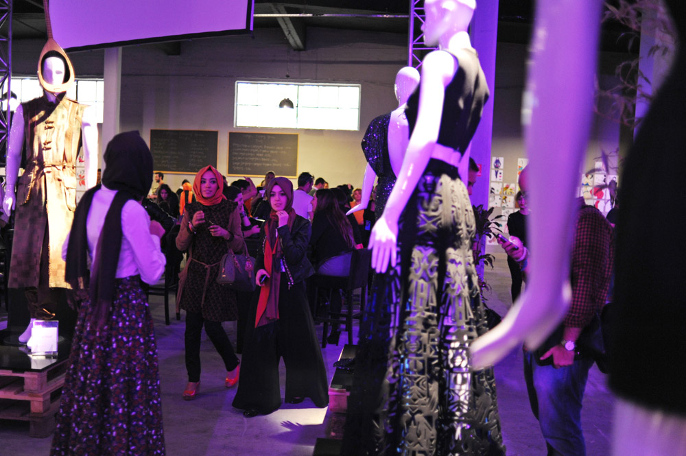 ISTANBUL, TURKEY.  Women are seen admiring different fashions showcased in the entrance at Antreppo 3 after the Erol Albayrak fashion show during Istanbul Fashion Week on October 11, 2012.