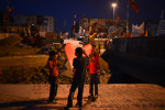 ISTANBUL, TURKEY.  Turkish children light a paper lantern at a protest in Taksim Square after a week of protests led to police being barricaded out of and withdrawing from the square as it transforms increasingly into a free, carnival-like zone in Istanbul, Turkey on June 6, 2013. The crisis which began over construction of a park and plans to reconstruct Ottoman barracks and a shopping mall has evolved into Turkey's biggest political crisis in decades as Turks express frustration with the current AK Party, Justice and Development Party, and Prime Minister Recep Tayyip Erdogan.