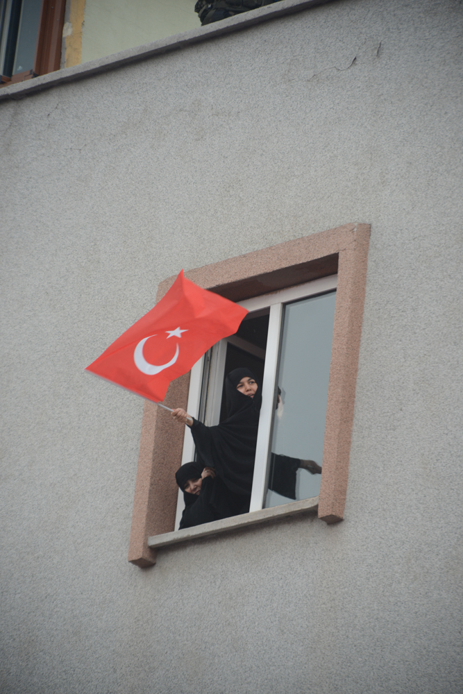 SINCAN, TURKEY.  Religious female supporters of the Justice and Development Party, AKP, and Prime Minister Recep Tayyip Erdogan lean out their window to hear Erdogan speak after more than two weeks straight of protests across Turkey against his rule on June 15, 2013. Sincan is the site of the 1997 {quote}post-modern coup{quote} and where Turkish Prime Minister Recep Tayyip Erdogan chose for his Ankara rally to bolster his position with regard to ongoing protests in Istanbul's Taksim Square and across Turkey; at his rally he said that the security services would promptly take care of the protesters and shortly after riot police were unleashed on the peacefully gathered demonstrators who quickly retook the square.