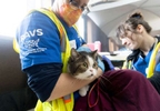 TAHOLAH, WASHINGTON - APRIL 21 : HSUS’s Rural Area Veterinary Services (RAVS) program, Taholah, Quinault Nation, WA. April 21, 2023. Vet Colleen Cassidy examines Violette Capoeman’s cat Kaotly. Photo by Ron Wurzer