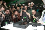Photographers crowd around to get pictures of the new Xbox after its unveiling by Microsoft. 