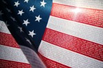 A Flag of Honor, containing the names of the 2,996 victims of the September 11, 2001 attacks flaps in the wind at the Healing Field memorial at Palm Mortuaries, Cemeteries and Crematories on the anniversary of 9/11.