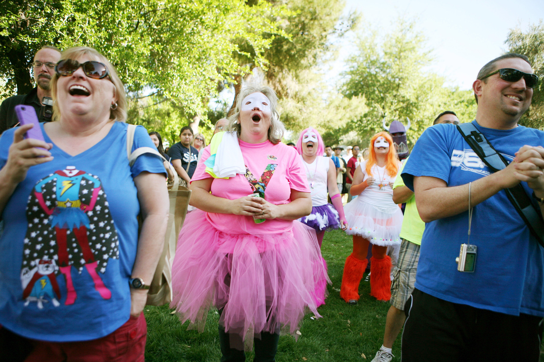 Mary Beth Zahedi, center, reacts as her fundraising Team Winos are announced winners during a rally prior to the start of the Aid for AIDS of Nevada (AFAN) 23rd Annual AIDS Walk at UNLV Saturday, April 14, 2013, in Las Vegas. Her teammates Mary Murphy, far left, Alicia Farrow, right center, and Tanya Paynter, right, stand nearby. The Winos won awards for highest fundraising team and most creative team. The team dressed as superheroes for the walk