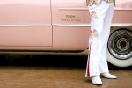 Eddie Powers, dressed as Elvis, stands near his 1956 pink Cadillac Sedan de Ville during the Cadillac Through the Years car show at The District at Green Valley Ranch.