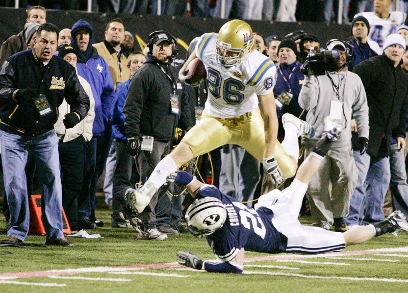 UCLA wide receiver Logan Paulsen jumps over BYU defender Ben Criddle after catching a pass late in the fourth quarter of the Las Vegas Bowlat Sam Boyd Stadium Saturday, Dec. 22, 2007. The Bruins drove into position for a 28-yard field-goal attempt by Kai Forbath, but the kick was blocked by the Cougars.