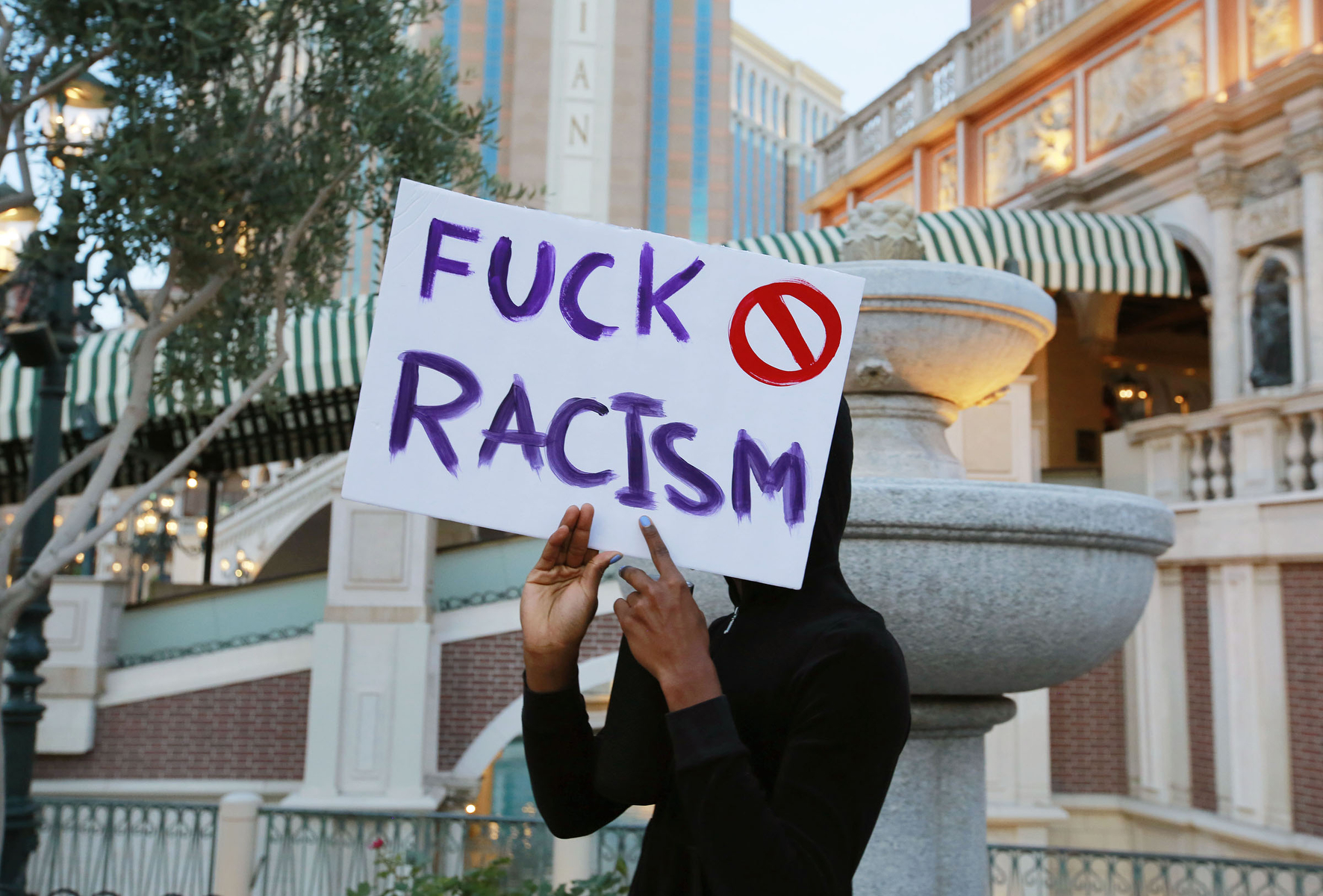 A woman holds a sign outside the Venetian hotel-casino during a Black Lives Matter protest along the Strip Monday, June 1, 2020, in Las Vegas. (Ronda Churchill/freelance)