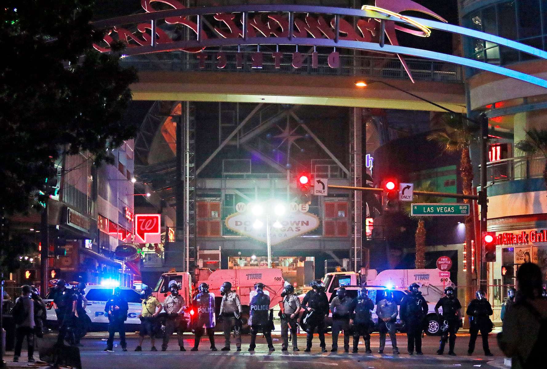 Police stand in formation at the entrance to Fremont Street Experience in downtown Las Vegas. Police were present for a community protest over the death of George Floyd, a Minneapolis man that died in police custody on Memorial Day. (Ronda Churchill/AP Photos)