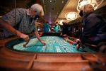 Gene Koonce (cq), left, of Drake, Colorado, plays craps at the reopening of Bellagio hotel-casino Thursday, June 4, 2020, in Las Vegas. (Photo by Ronda Churchill/AFP)