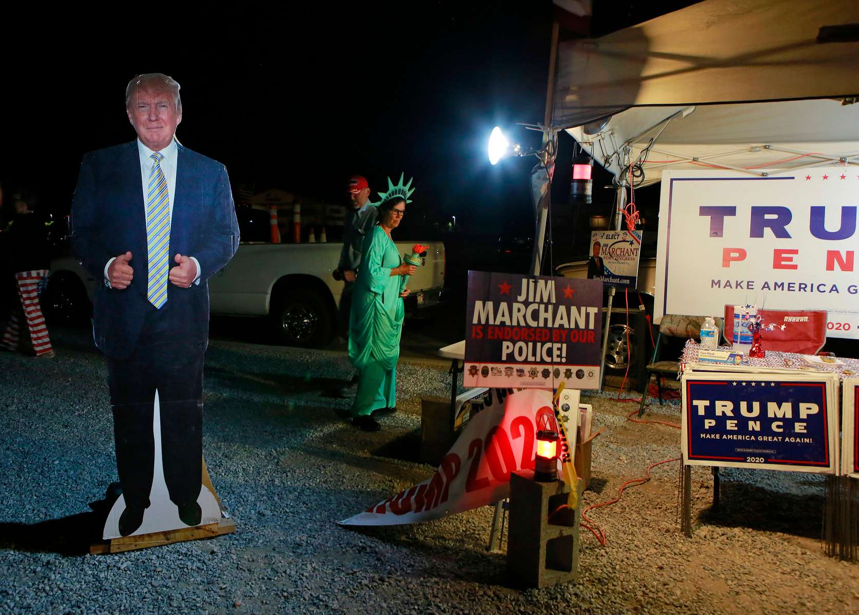 Pamela Morgan, dressed as Lady Liberty, and a President Trump cardboard cutout are shown near Bob Ruud Community Center on Election Day Tuesday, November 3, 2020, in Pahrump, Nevada. A tent of Trump supporters were set up within guidelines adjacent to the polling station.
