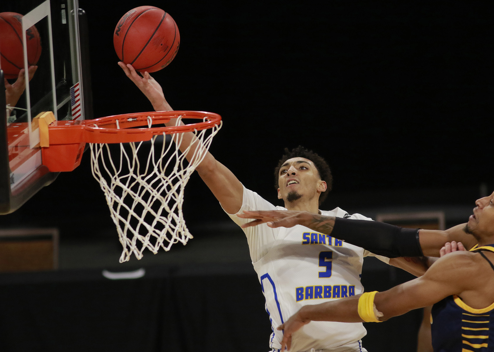 UC Santa Barbara’s Miles Norris (5) goes for a shot past UC Irvine’s Austin Johnson (13) during the second half of an NCAA college basketball game for the championship of the Big West Conference men’s tournament.