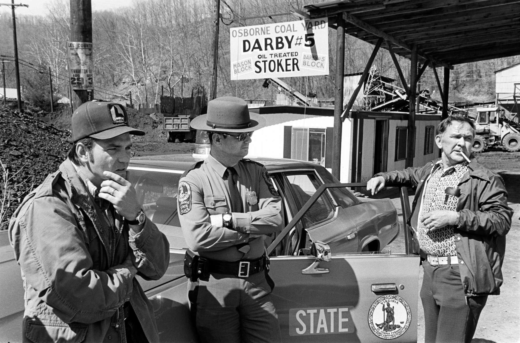 State police patrol the Osborne Coal Yard near Pennington Gap, VA during the 1978 national bituminous coal strike led by the United Mine Workers of America. The strike lasted 110 days. When it was settled, coal miners were forced to pay for part of their health care for the first time in 30 years, they lost their pension benefits, and they lost the right to strike over local issues. By 2014, coal mining had largely shifted to open pit mines in Wyoming. The once 200,000-strong UMW was reduced to just 20,000 miners, mostly in underground mines in Kentucky and West Virginia. Jon Chase photo