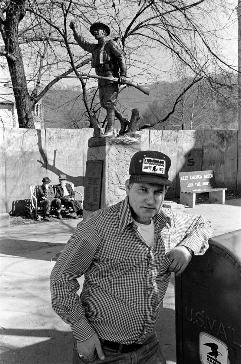 Striking coal miner passing time at the public square in Harlan, Kentucky, on the hundredth day of a coal strike, 1978. Harlan has a long and storied history of coal strikes and violence dating back to the 1930's, when the song “Which Side Are You On?” became the anthem of a reborn United Mine Workers (UMWA) union. As recently as 2019 miners in Harlan County occupied a railroad track to halt a coal train until they got paid the back wages they were owed for loading that train. There is no longer a miner's union in Kentucky. Jon Chase photo