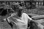 Woman wearing a Cadillac hat in her yard in an all-Black, back hills hollow in West Virginia, 1978. Jon Chase photo