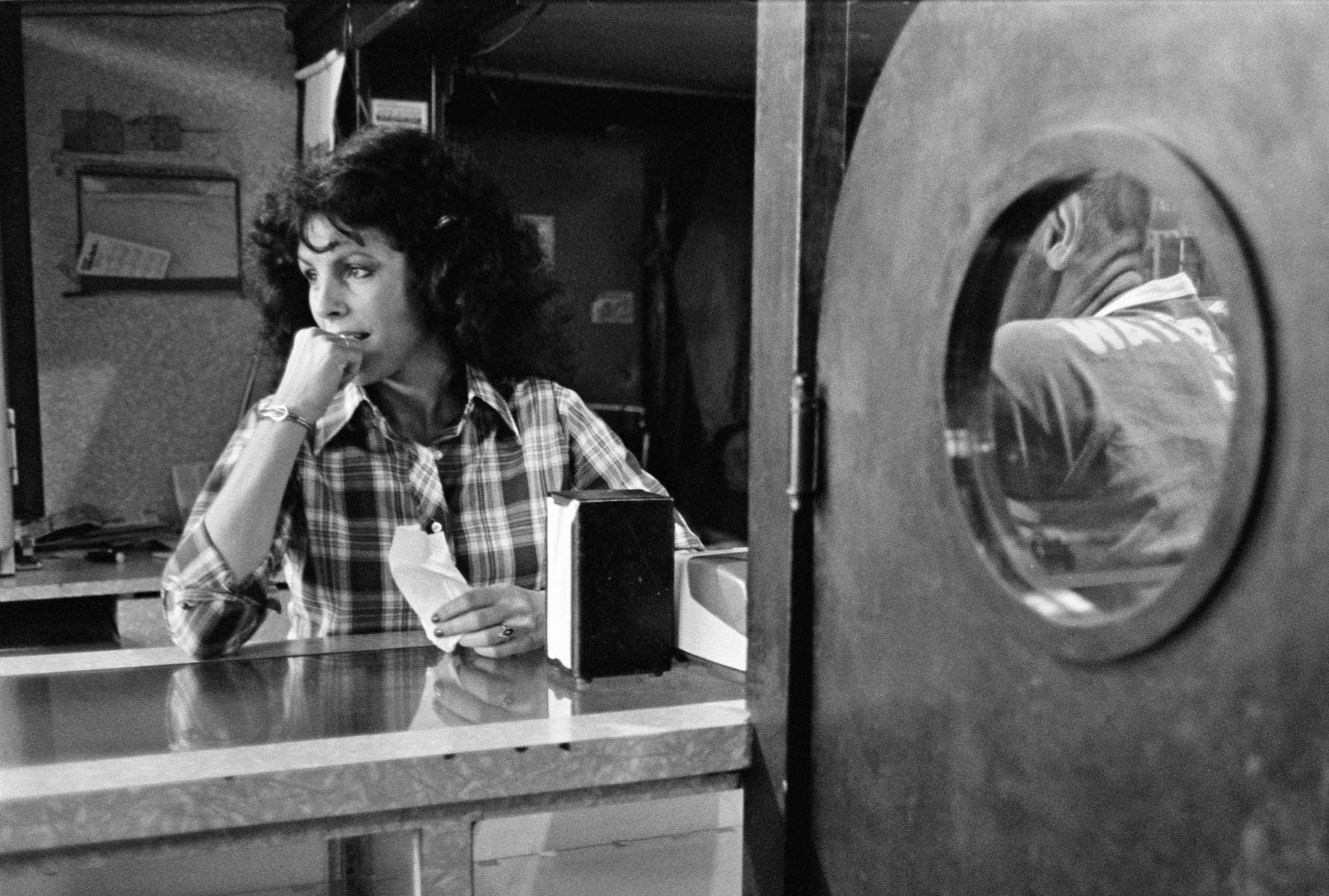 Woman barkeeper perhaps daydreaming of places far removed from where she works, West Virginia, 1978. At one point, more than 100,000 West Virginians worked in the mines that produced well-paying jobs. Now there are fewer than 20,000, and the jobs that do exist pay far less than they used to, thanks to successful anti-union actions by coal companies. Coal counties in Appalachia suffer high rates of heart disease, obesity, smoking, diabetes, and opioid abuse, leading them to have some of the lowest life expectancies in the country.  Jon Chase photo