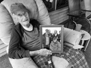 Ninety-five-year-old Claude Yeager holds a photo of himself with cousin Chuck Yeager, the legendary Air Force General, flying ace, and fighter jet test pilot, on his porch in Micco, West Virginia. Chuck Yeager became the first pilot in history to break the sound barrier in level flight. 