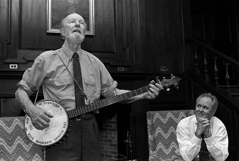 © 2010 Harvard University. Legendary folksinger Pete Seeger performs a song as actor John Lithgow watches.