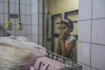 JULY 25, 2016 -- Veronica Pereira, 10, watches her sister, Duda, under the care of Dr. Regina Coeli, director of the children's infectious diseases, at the Oswaldo Cruz University Hospital, in Recife. Duda was hospitalized for a lung infection created by complications with seizures. She hasn't been able to swallow food, so doctors placed a food tube in her. 