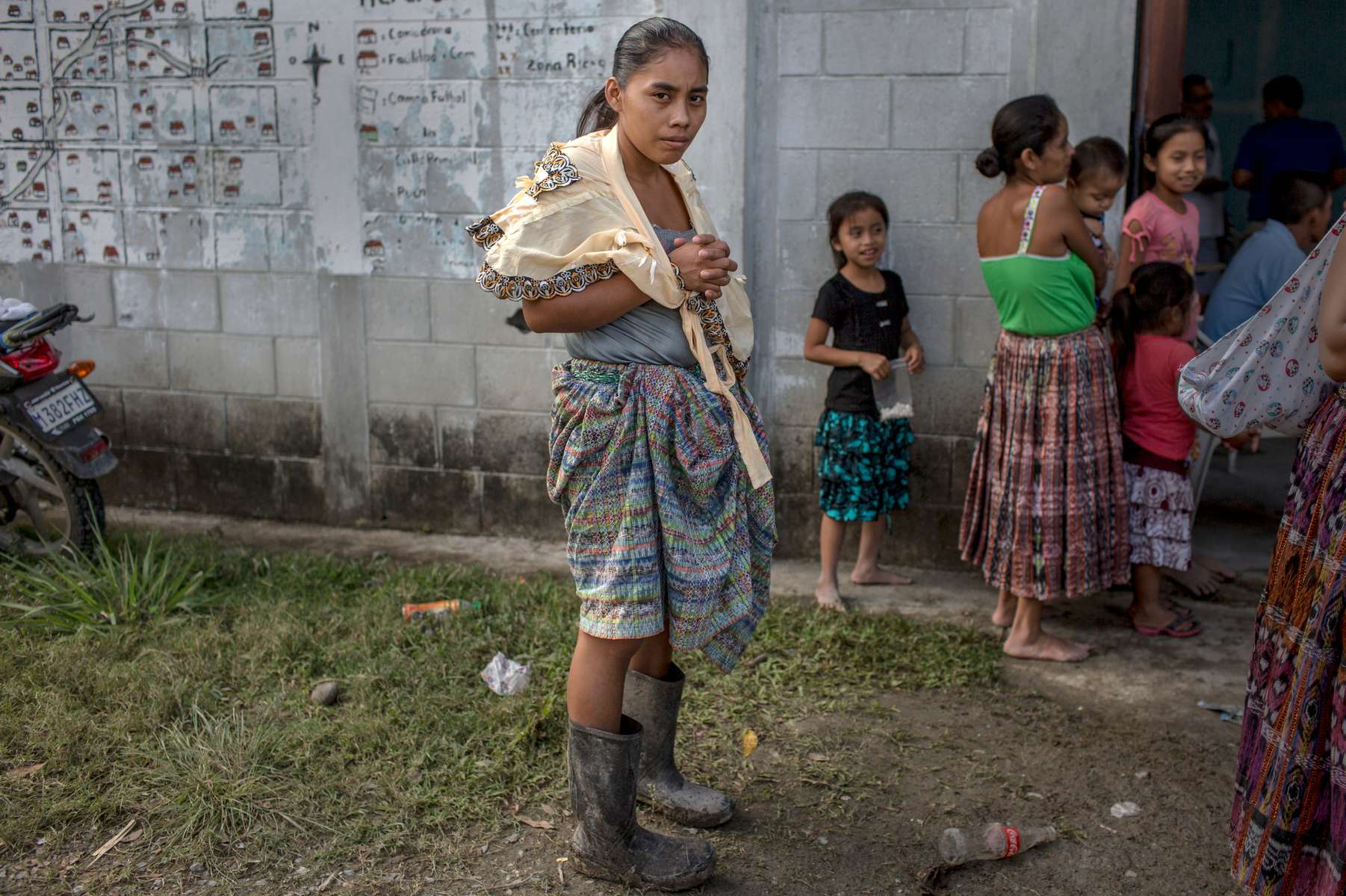 EL ESTOR, GUATEMALA. February 12, 2018 – An indigenous Maya Q'eqchi woman waits outside the community center while mobile health clinic visits patients, in a community near El Estor, in the Polochic Valley, Guatemala. The community is divided between villagers who want to work for a palm oil and banana company, and those that are trying to fight it for rights to more land. 