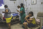 JULY 25, 2016 -- Cleane comforts Duda after doctors remove a feeding tube that bent because it was too large for her, causing discomfort. Duda was hospitalized for a respiratory infection due to her seizures, at Oswaldo Cruz University Hospital in Recife. 