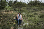 Luz Angela Velasquez waits for the army to return about news of a recent mass grave along a hillside where the city uses to dump construction waste, in Medellin, Colombia. Her son disappeared from a paramilitary that operated in Communa 13, one of the most violent communities in Medellin. Velasquez is part of a group of women who have been fighting for exhumations.