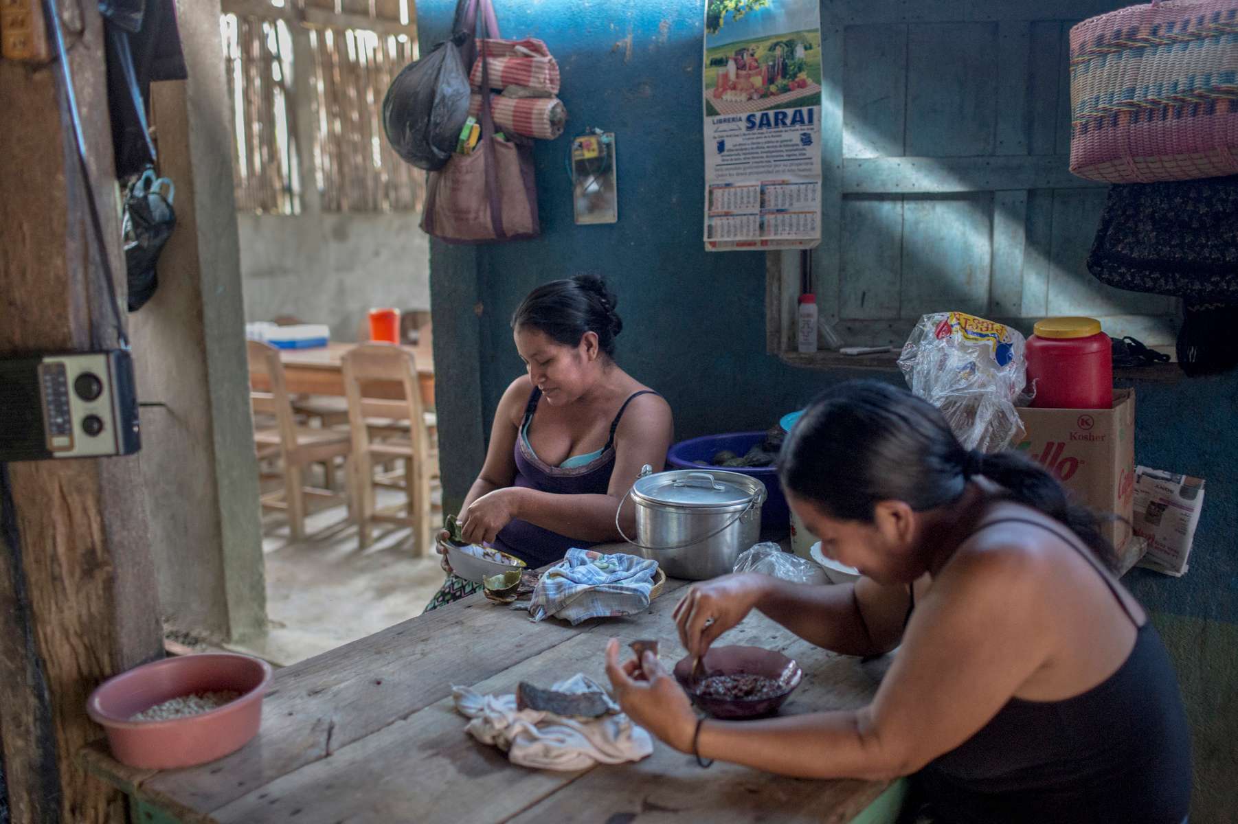 IZABAL, GUATEMALA. February 13, 2018 – Marta Julio, 42, right, opened her restaurant to cater to environmental defenders, NGOs, and palm workers. {quote}My restaurant helps pay for my son's private school tuition.{quote} Indigenous Maya Q'eqchi communities such as Chapin Abajo .along Lake Izabal in eastern Guatemala, have no state presence. There is no police. Only a palm oil company provides jobs and health services. In the last 20 years, palm oil plantations in the region replaced former cattle ranches but it has exacerbated the struggle for land rights in the Polochic Valley. In Guatemala, only four percent of producers control 80 percent of the land. Approximately 60 percent of citizens live in poverty but rises to 80 percent among the indigenous communities. {quote}The indigenous population was always seen as cheap labor and this persists to this day,{quote} said Alvaro Pop, Chair of the United Nations Permanent Forum on Indigenous Issues. {quote}They are seen as a tool and are not the focus of public policies.”According to a 2006 UN report on {quote}The right to food,” Guatemala’s land policies were deliberately designed to create cheap labour forces by reducing the land available for indigenous people's own subsistence activities. The country has a long history of exclusionary development that has left indigenous communities without land or labour rights and subject to pervasive racial discrimination, the report said.