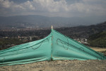 A tarp surrounds a mass grave site that lays untouched for about 10-years as families of the disappeared still await when the government will exhume bodies from the area, near Communa 13, in Medellin, Colombia.
