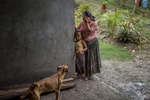 EL ESTOR, GUATEMALA. February 12, 2018 – An indigenous Maya Q'eqchi woman with her daughter visiting a neighbor. Some residents work for a nearby banana and African palm oil company which has created in their community. Those workers face threats from residents because of their employment. 