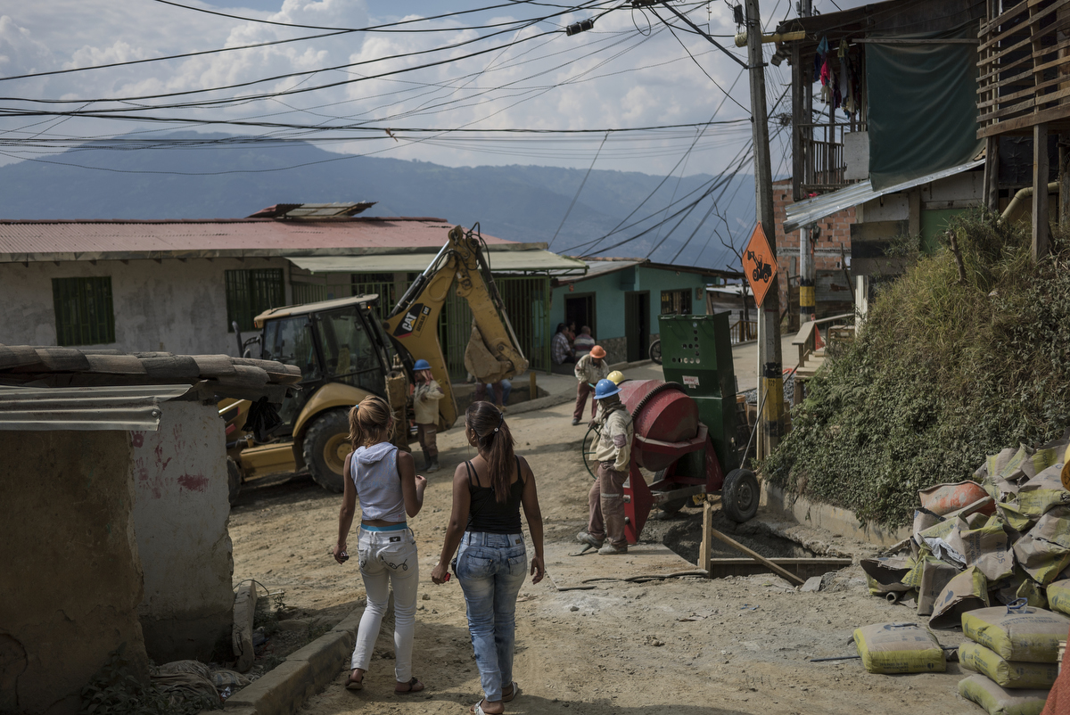 City employees work on adding water pipes in the poorest region of Medellin where hundreds of families do not have access to clean drinking water despite the city having the best water treatment plant in South America. Construction began when community protested for clean drinking water seven years ago, but the project has yet to finish. Many residents are displaced victims from the half-century long conflict.
