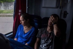 Marco Moron, left, tired from the long journey from Caracas, sits on the bus with his girlfriend, Ariana Zamora, in Pacaraima, where they will travel to Boa Vista, and then catch a flight to Rio de Janeiro, and eventually to Buenos Aires, in Pacaraima, Roraima state, Brazil, on Saturday, August 26, 2017. Since last year, 30,000 Venezuelan refugees have arrived in the border state of Roraima, according to Reuters. Venezuelans come in search of refugee status, temporary work, and urgently needed medical services. The wave of Venezuelans is putting pressure on Roraima's public health care system, which some officials say was already overstretched, and {quote}clogging Brazil's system for processing asylum applications,{quote} according to Human Rights Watch.