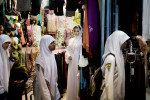 Students walk past a veiled, caucasian looking mannequin in a market in Banda Aceh, Indonesia, Thursday, Nov. 19, 2009. Since the provincial government of Aceh Province implemented a moderate form of sharia law on conduct and dress in Aceh, dozens of Muslim clothing shops opened in the markets and malls.